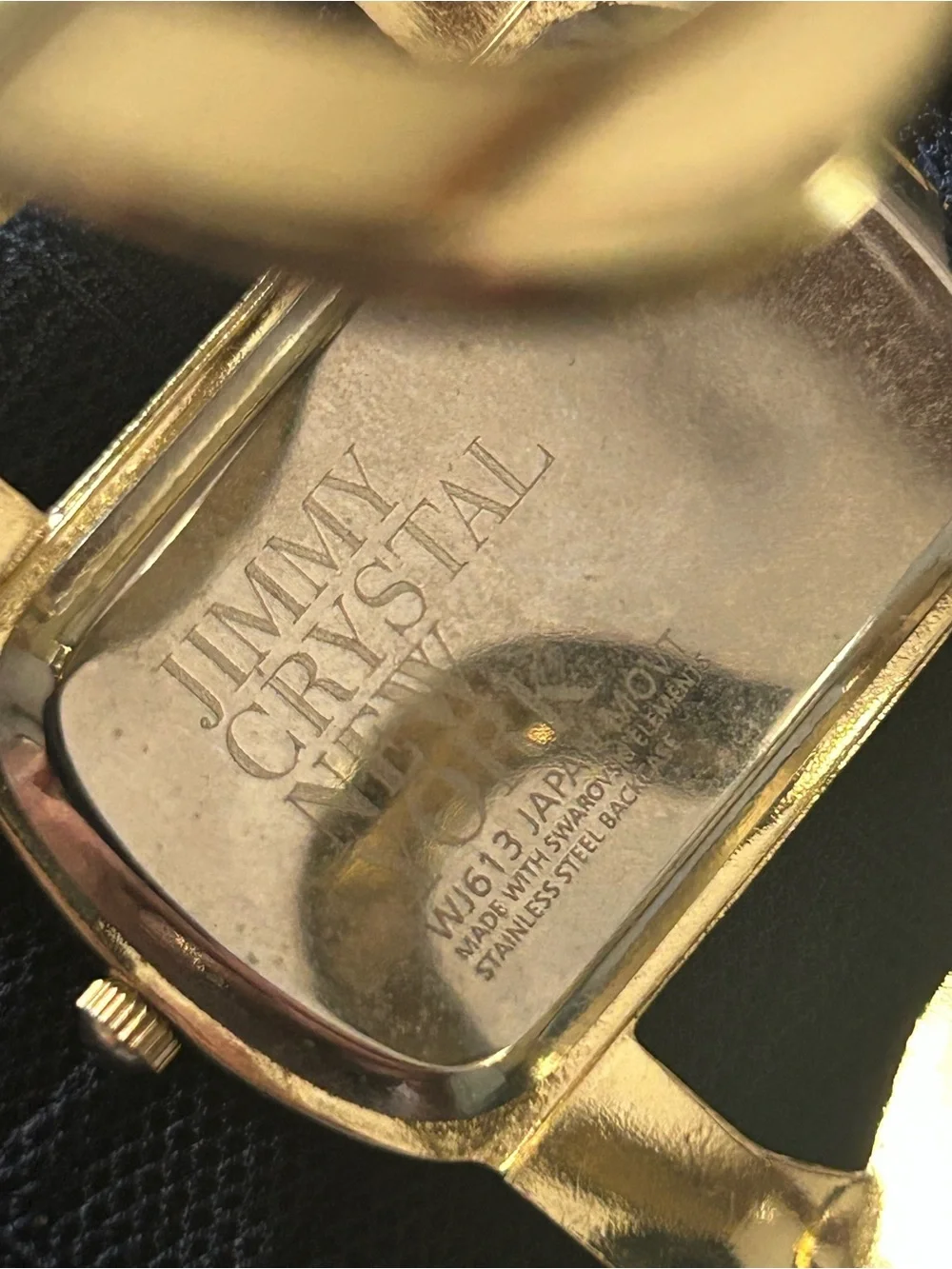 Jimmy Crystal elegant gold tone cuff watch with sparkling crystal accents.